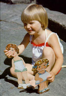 Image: Girl playing with paper dolls, by Janke