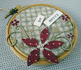 Embroidery hoop Christmas decoration with poinsettia in traditional colours 