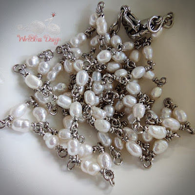 Wire wrapped rice pearl face mask chain on a white dish