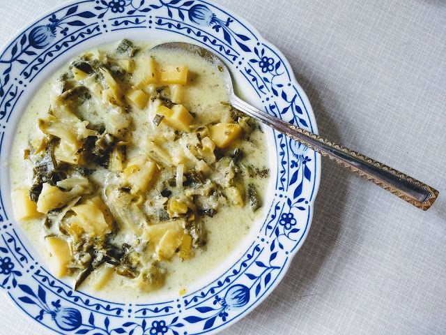 A plateful of colcannon soup with visible pieces of potato, cabbage and leek