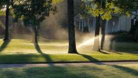 auto sprinkler system watering the grass during 2016 drought