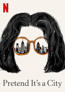 painted black hair and sunglasses with a skyline reflected in them