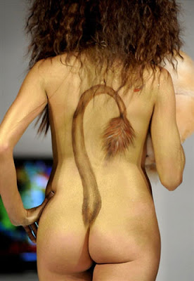 A lion tail tattoo on the girls naked back