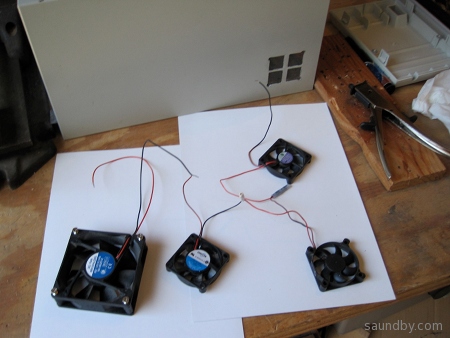 Four 12V fans wired in series, and one side of the cabinet with enlarged air vents.