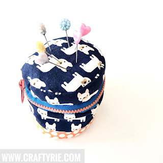 A cute zippered pin cushion made from scrap fabric made by CraftyRie.