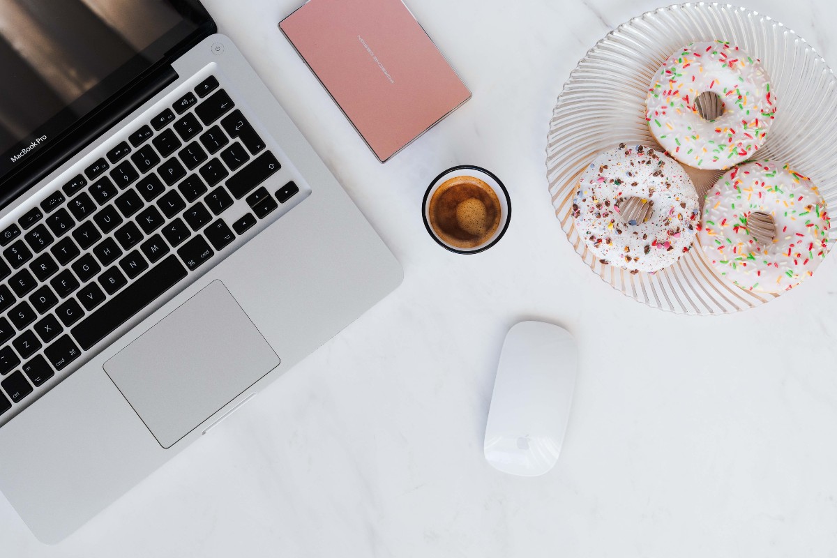 Laptop, donuts and coffee flatlay