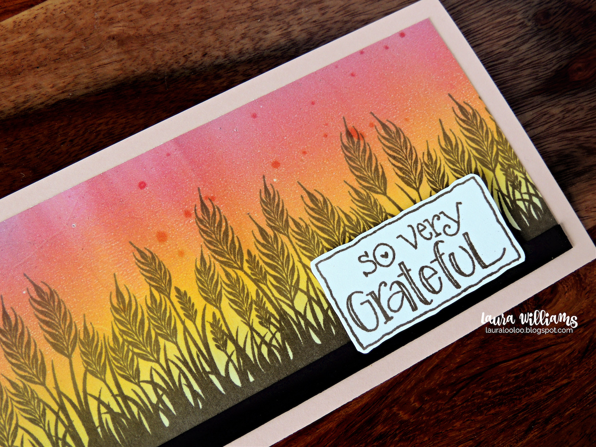 This is a slimline size handmade card (8.5x3.5") It features a wheat field stamped onto a blending pink, orange, and yellow sky that looks like sunrise or sunset. The sentiment says So Very Grateful. This would be a perfect handmade card for autumn thank you cards, or Thanskgiving cards. All of the stamps are from Impression Obsession.