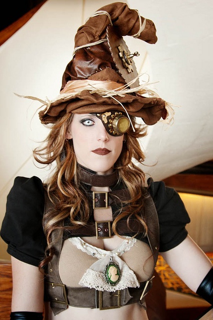 Steampunk Halloween costume ideas for women. This steampunk witch has a witch's hat, monocle/eyepatch/goggle, victorian cameo bra, harness and gloves.