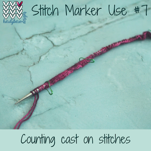 blue background with knitting needle with lots of stitches cast on in magenta