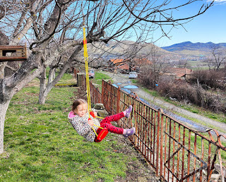 Rosie swings on her new big girl swing