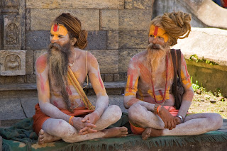 Two Sadhus, or Hindu Holy Men, near Pashupatinath temple in Kathmandu, Nepal. Usually, sadhus live by themselves, on the fringes of society, and spend their days in devotion to their chosen deity — Luca Galuzzi — CC-by-SA 2.5