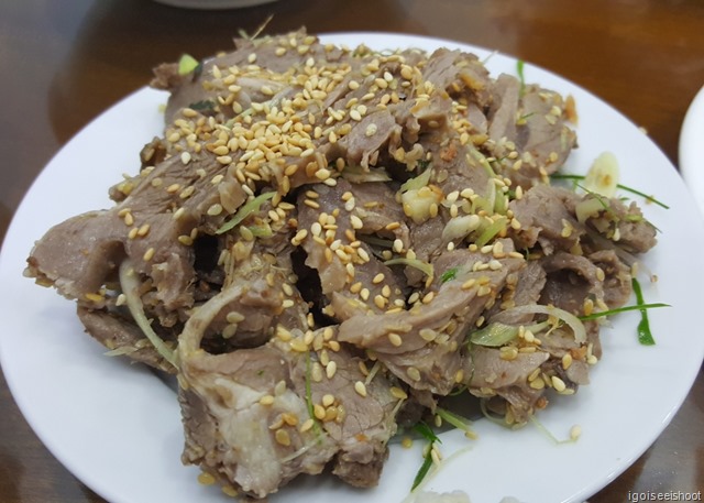 Stir-fried mountain goat meat with herbs and sesame seeds.