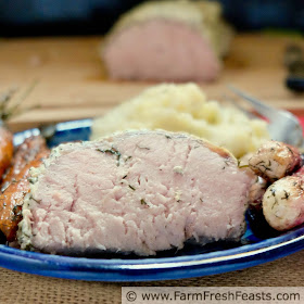 close up image of roast pork with yogurt, mustard, and fresh dill