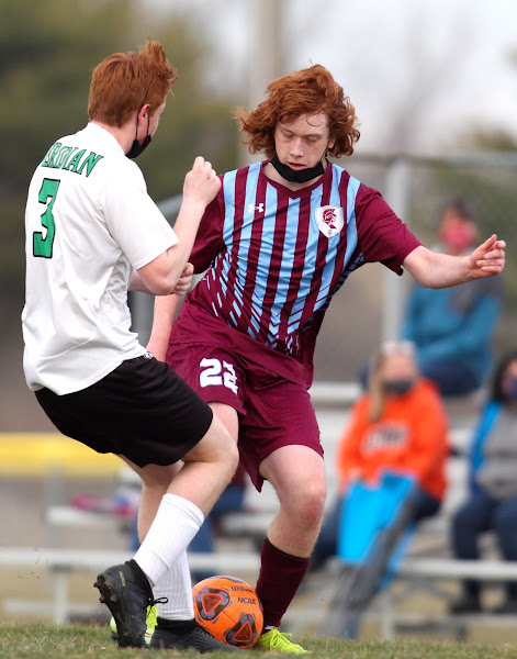 St. Joseph-Ogden's Jared Emmert passes the soccer ball