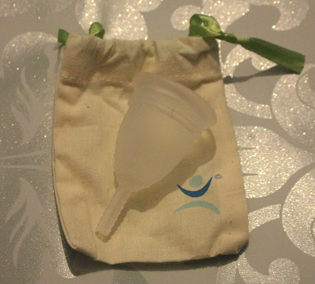 Picture of the mooncup outside of it's cotton bag