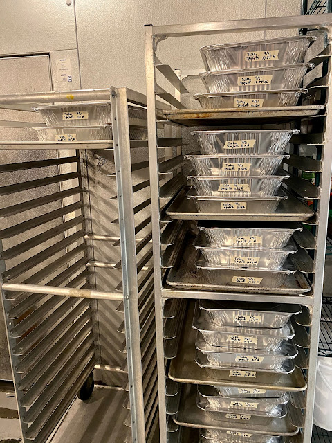 image of a speed rack filled with 237.85 pounds of turkey spaghetti in steam trays