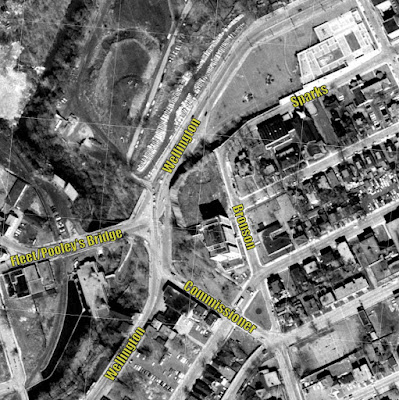 Top-down black-and-white photo of the area around the Wellington/Fleet/Commissioner elongated intersection and Sparks/Bronson, with the recently completed Garden of the Provinces Park at the top right