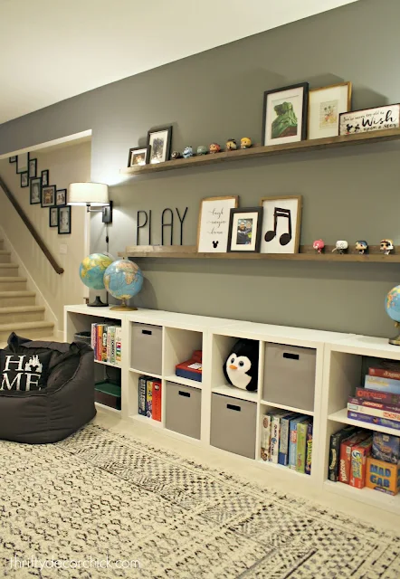 Create a wall of toy storage and picture ledges