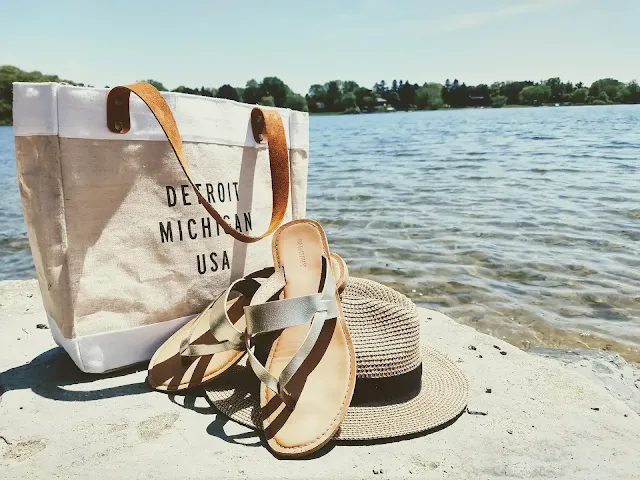 Sandals and handbags near a beach