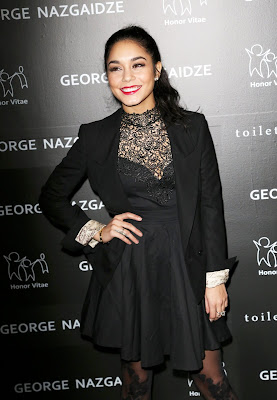 Vanessa Hudgens wearing fit-and-flare dress with a matching blazer, booties, and tights which had a sexy vine pattern scaling her legs