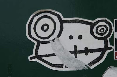 Graffiti image of a sticker of an alien goat from the Old Town centre of Genoa, Italy.