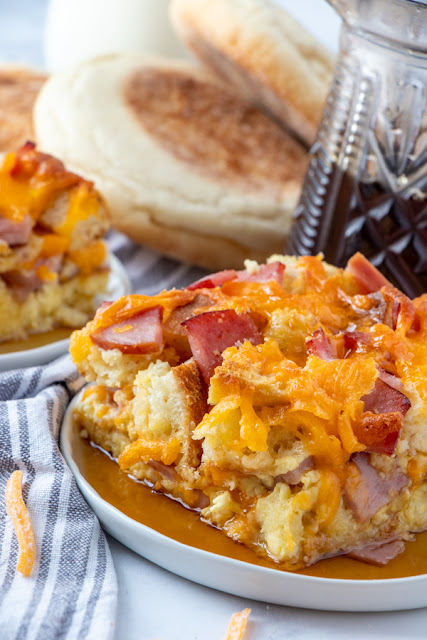 This delicious breakfast casserole has all the ingredients of McDonald's Egg McMuffins combined together and baked! Use Canadian bacon, sausage or regular bacon, and any cheese you prefer! Drizzle maple syrup on top for that delicious sweet and savory flavor combo! Make this for holiday brunch or dinner instead of breakfast!