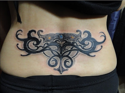 totem-like lower back tattoo