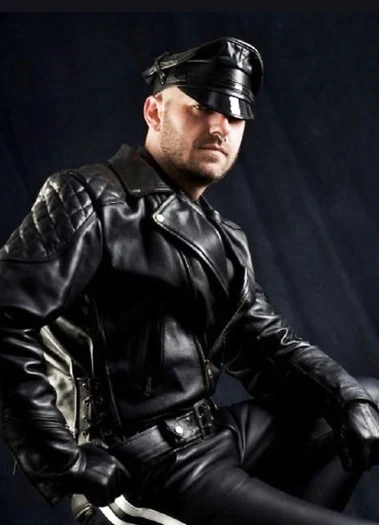 Good looking leather Daddy from full black leather years staying into the camera