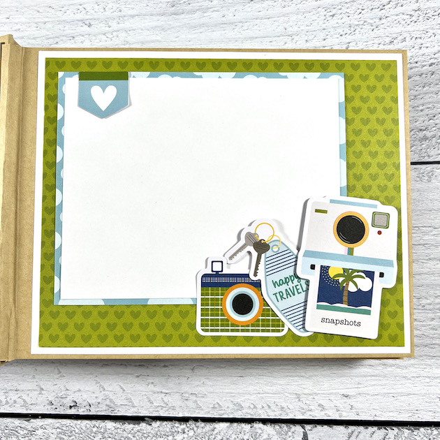 Travel scrapbook album page with camera and hearts for vacation photos