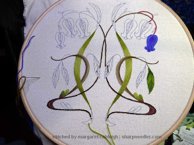 Progress made on embroidering the left side of this crewel bluebells project.
