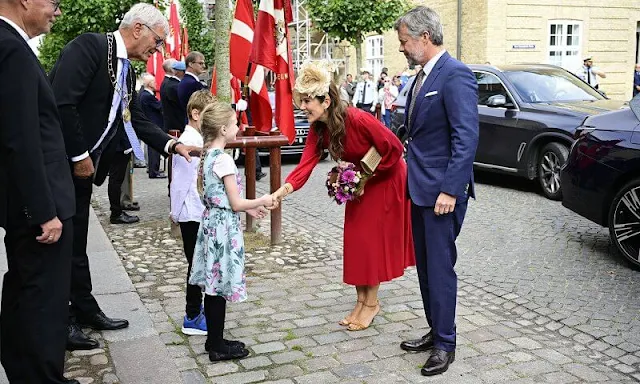 Crown Princess Mary wore a red Armonia silk georgette dress by Raquel Diniz. Crown Prince Frederik