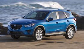 Blue 2014 Mazda CX-5 front 3/4 view by ocean.