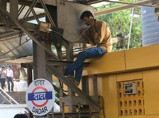 MAN CHARGING PHONE AT DADAR RAILWAY STATION