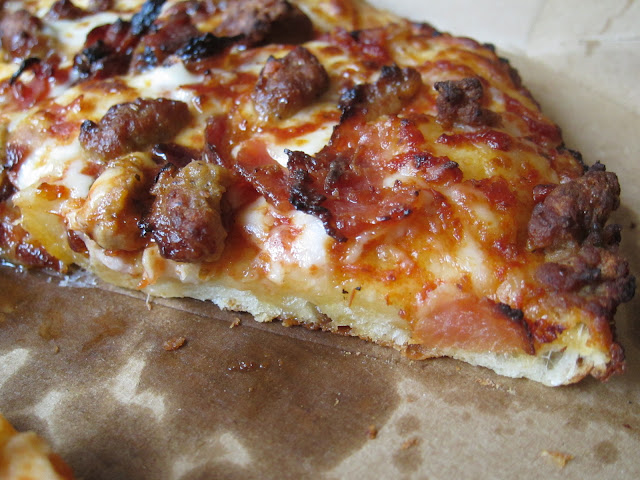 A close-up of the cross-section of Domino's Handmade Pan Pizza.