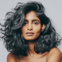 Female with curly black hair.