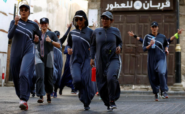 Women run during an event marking International Women's Day in Old Jeddah on March 8, 2018. (REUTERS/Faisal Al Nasser)