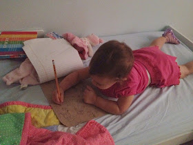 baby girl drawing in bed