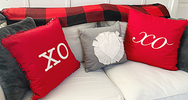 red and grey pillows on white sofa