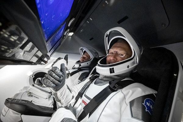 After getting seated inside their Crew Dragon capsule Endeavour, NASA astronauts Douglas Hurley and Robert Behnken pose for a photo before launch on May 30, 2020.