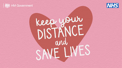 Keep your distance and save lives. Red heart on a pink background