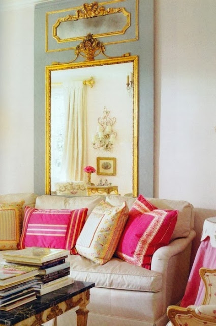 white living room hot pink blue gold accents oversized mirror