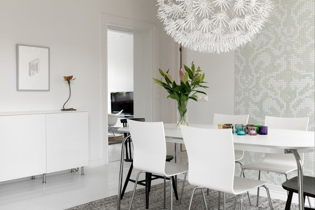 bo-laget dot se dining room with oversized ikea paper chandelier, gray and white walls, a white table surrounded by white and black