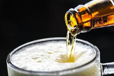 pouring beer into a glass