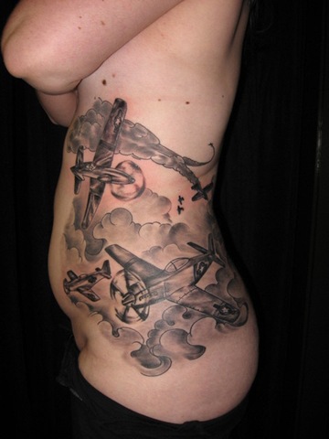 of her P-51 Mustang dogfight tattoo on the side of her ribs and stomach.