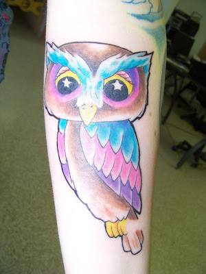 Cartoon owl with star eyes tattoo.