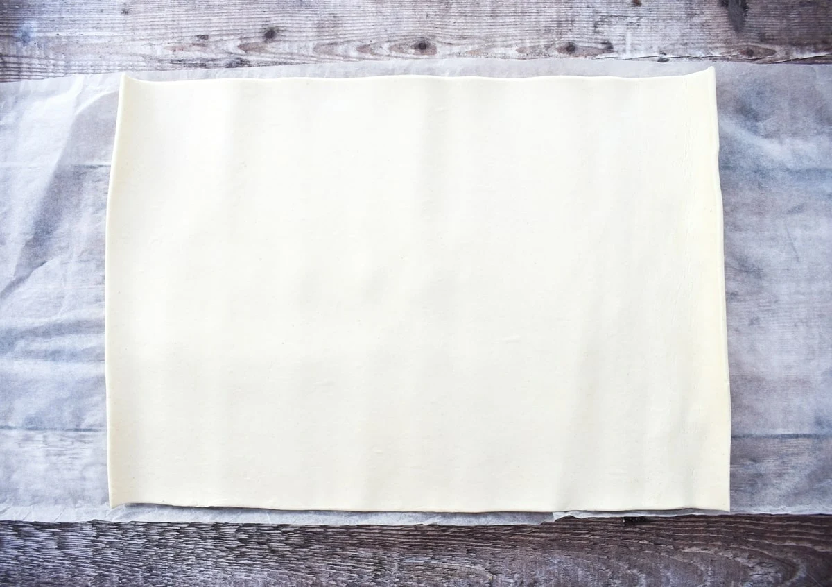 ready-rolled puff pastry on a parchment sheet.