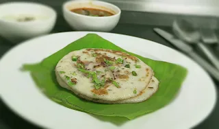 srving onion uttapam with coconut chutney and sambhar