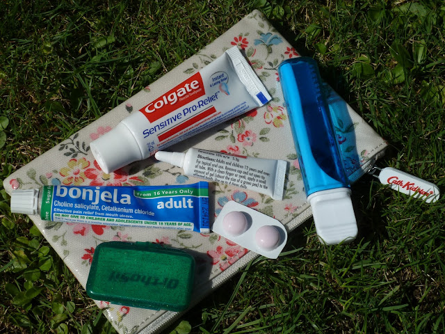 A photo of my Cath Kidston Purse containing my essential products for looking after my brace while out and about