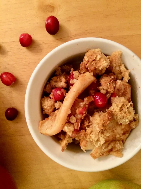 Serving bowl of cranberry apple crisp.