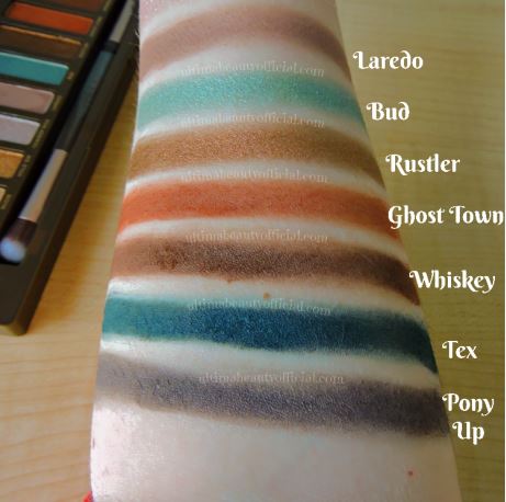 Swatches of Urban Decay Naked Wild West Palette on Ultima Beauty’s arm. Shades: Laredo, Bud, Rustler, Ghost Town, Whiskey, Tex, Pony Up